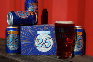 21st Amendment Brewery's 25th Anniversary IPA 6-pack and cans alongside a pint